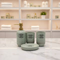 Luxury ceramic bathroom accessories set featuring a soap dispenser, toothbrush holder, tumbler, and matching tray for stylish bathroom decor.
