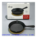 Durable cast iron skillet with natural bamboo tray for cooking, baking, and serving hot meals.