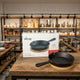 Premium mini cast iron skillet with bamboo serving base for restaurants, home kitchens, and food presentation.