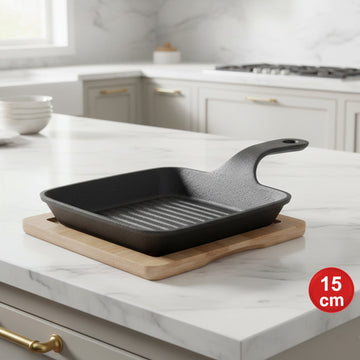 Premium cast iron square griddle pan with wooden serving base for grilling meat, seafood, and vegetables.