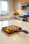 Premium cast-iron square skillet with bamboo serving base for grilling meat, seafood, vegetables, and appetizers.