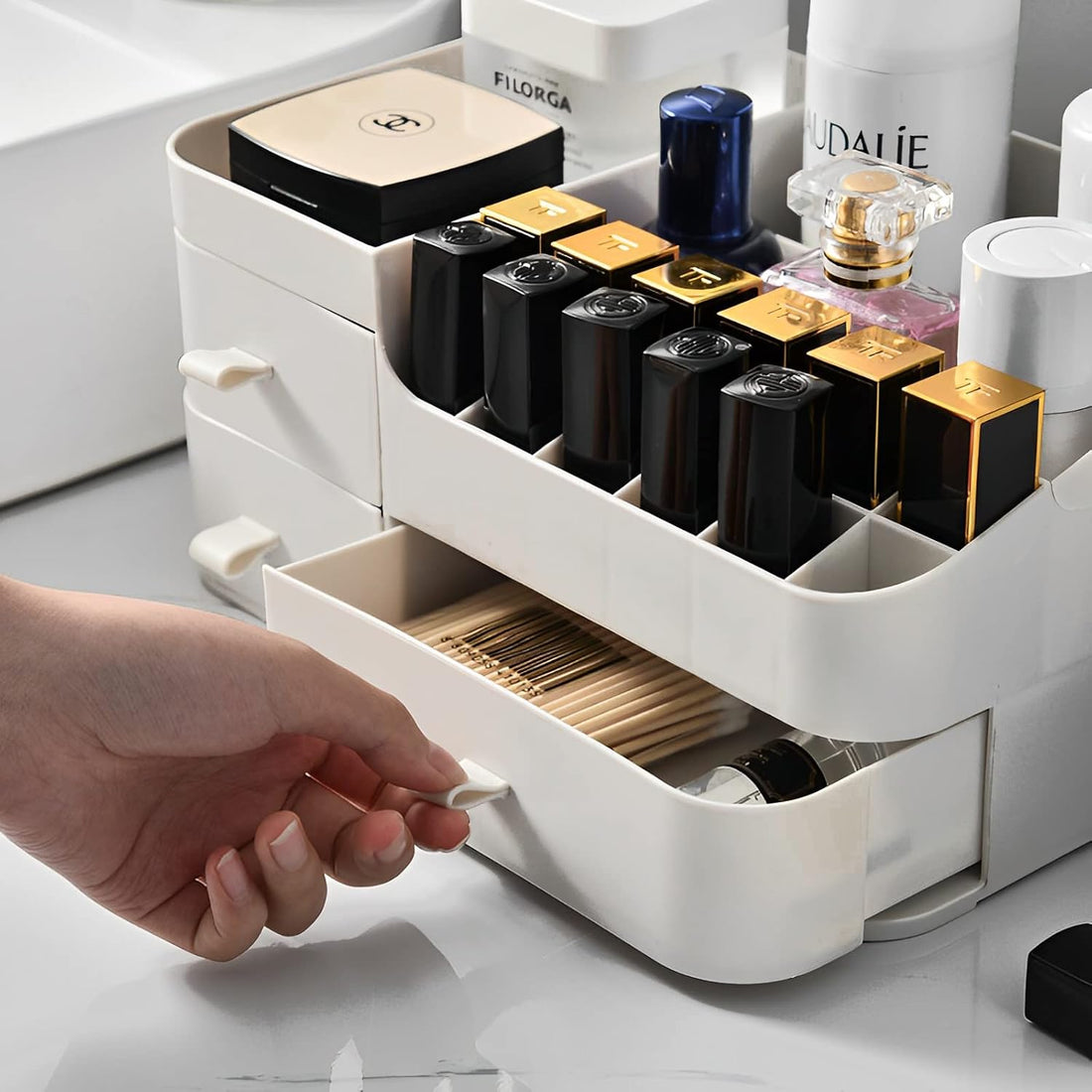 Cosmetic organizer with skincare products on a wooden desk, reflected in a round mirror.